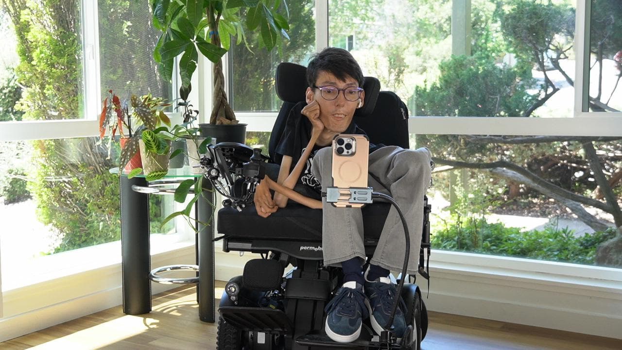Portrait of vahid Rajablou, developer and founder, seated in his power wheelchair.